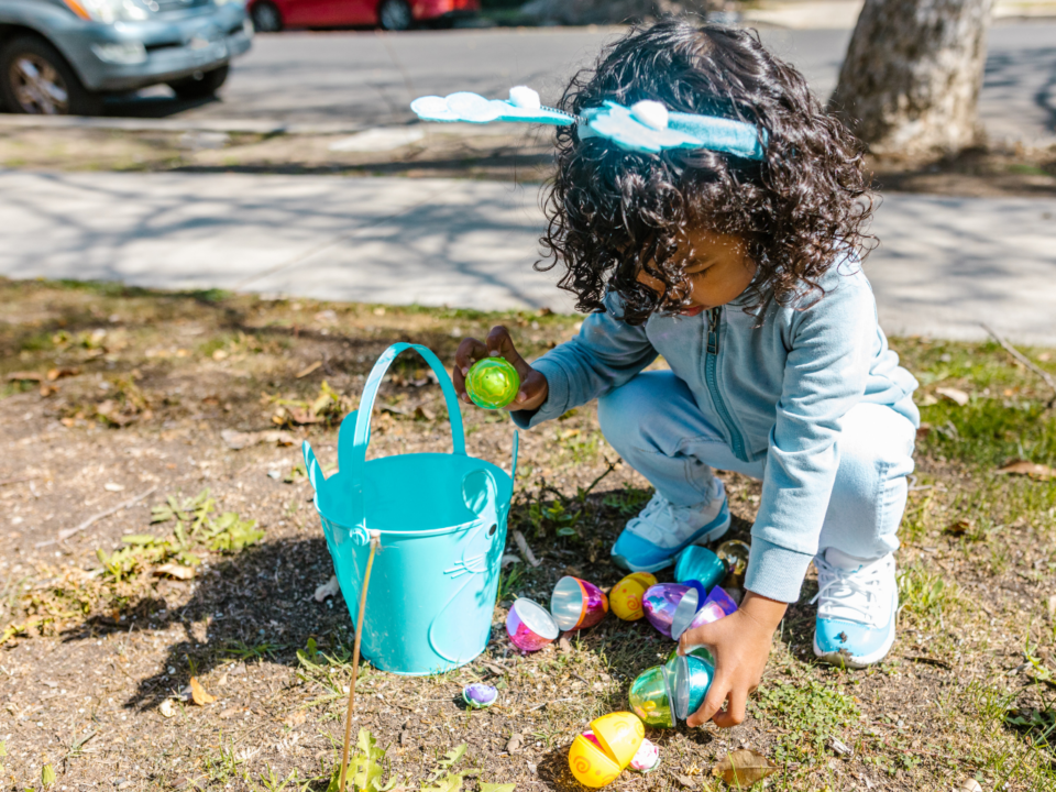 easter egg hunt; girl picking up easter egg