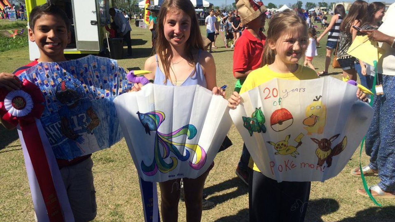kids holding kites at kite fest louisiane
