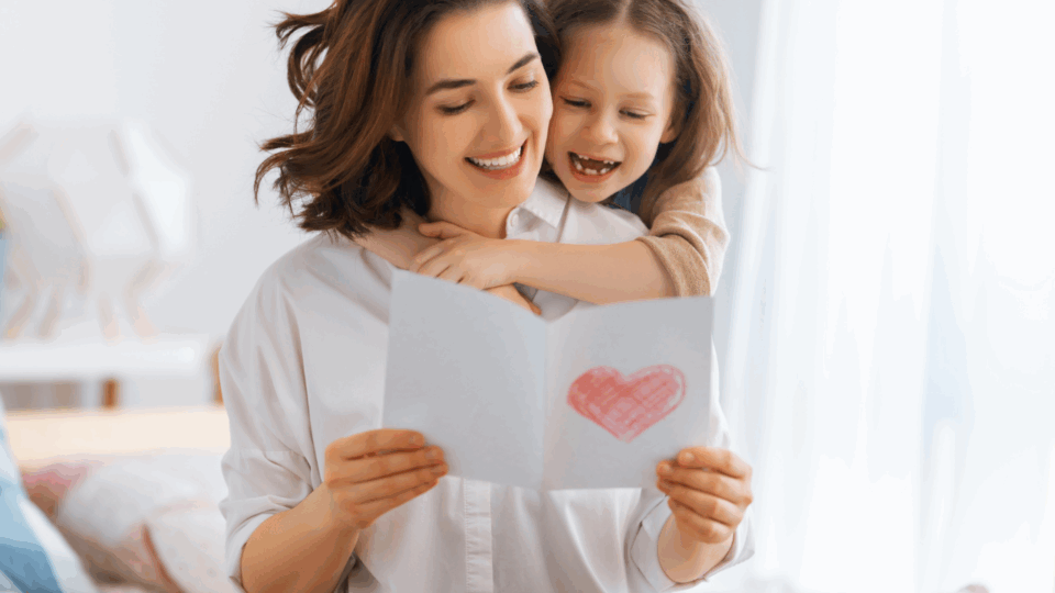 child giving mom a mother's day cards