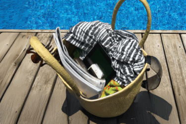smartphone in beach bag next to a pool for the phones down, eyes up campaign