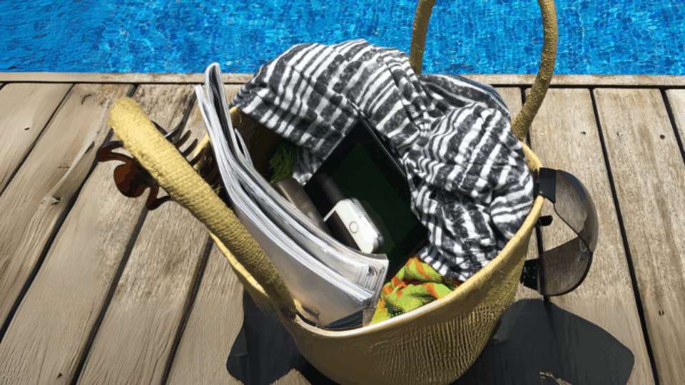 smartphone in beach bag next to a pool for the phones down, eyes up campaign