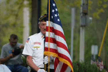 memorial day weekend events man holding flag