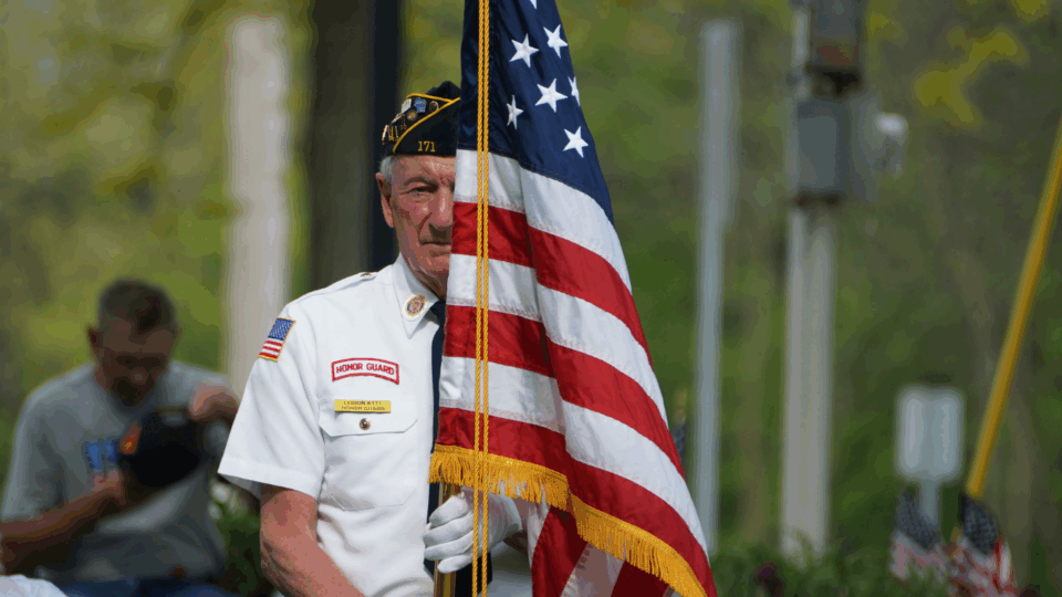 memorial day weekend events man holding flag