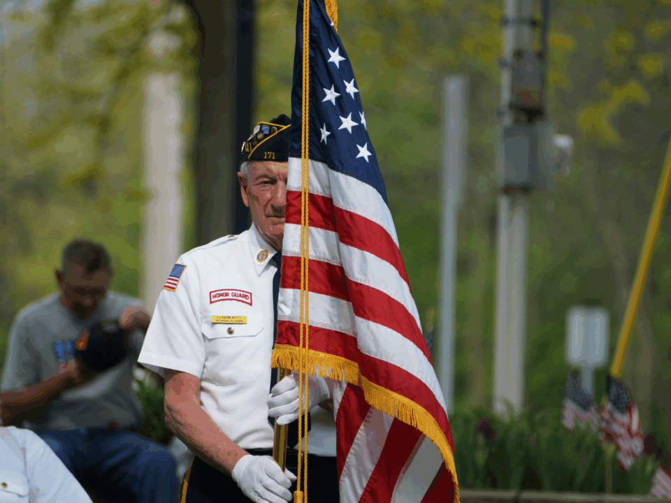 memorial day weekend events man holding flag