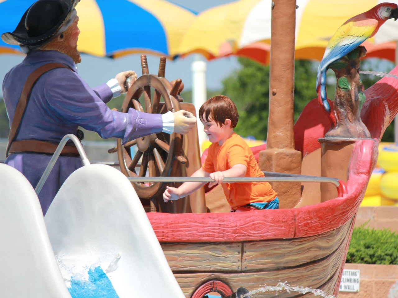 weekend getaways: gulf shores; boy playing on water fixture at waterville