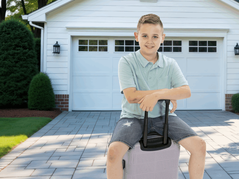 boy sitting on luggage for weekend getaways