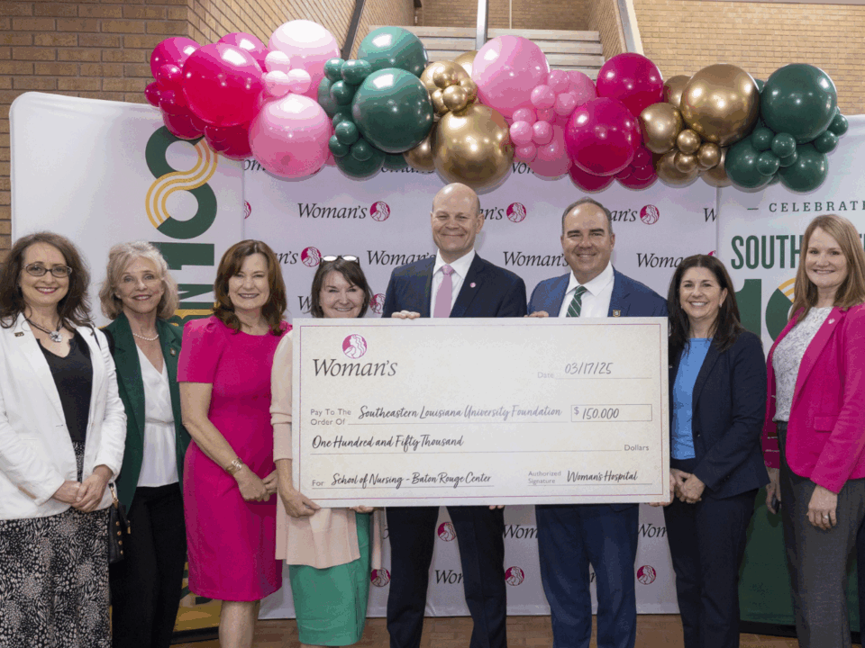 woman's hospital presenting check for southeastern's nursing and simulation lab