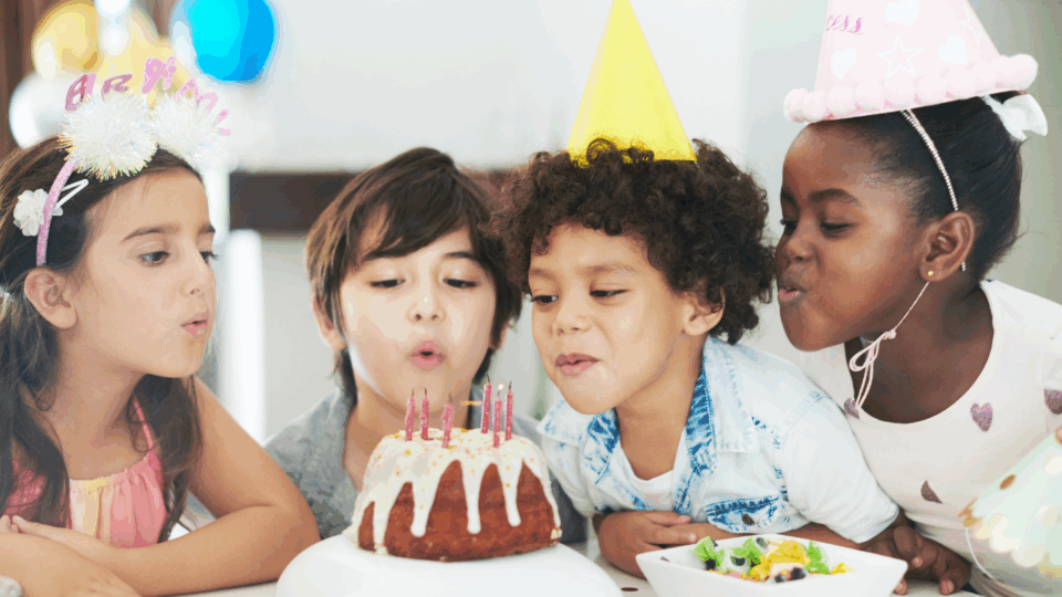milestone birthdays; kids blowing out birthday candles