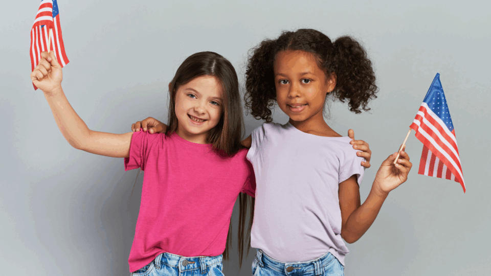 two girls holding american flags for patriotic crafts