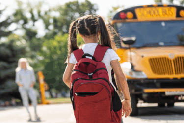 back to school giveaway; girl walking to bus
