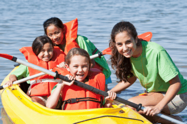 summer camp checklist; kids in canoe at camp