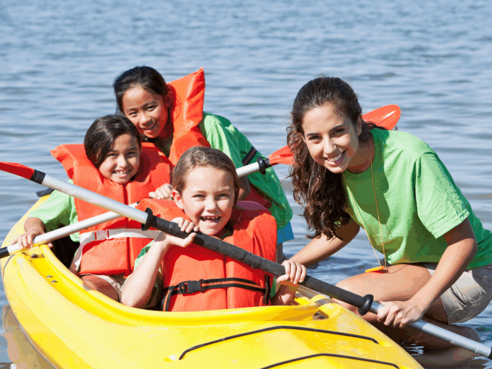 summer camp checklist; kids in canoe at camp