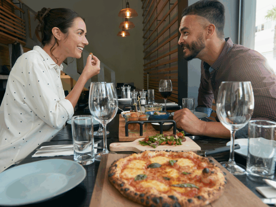 Parents-Only Getaway; a mom and dad on a date eating pizza