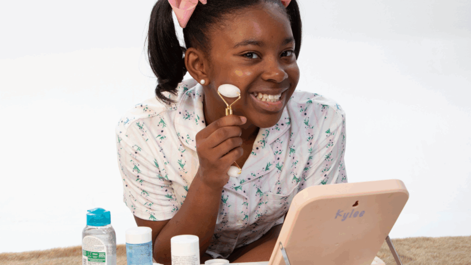 girl using face roller; skincare