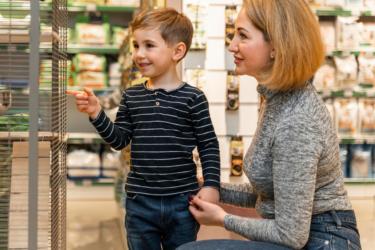 teaching true value; mom with son at store