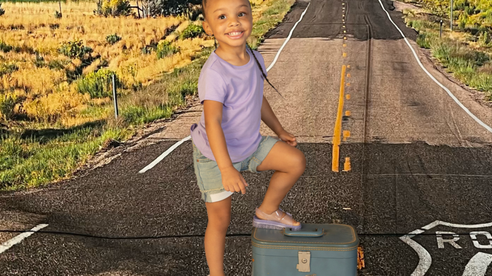 family trips; girl with foot on suitcase on route 66 backdrop