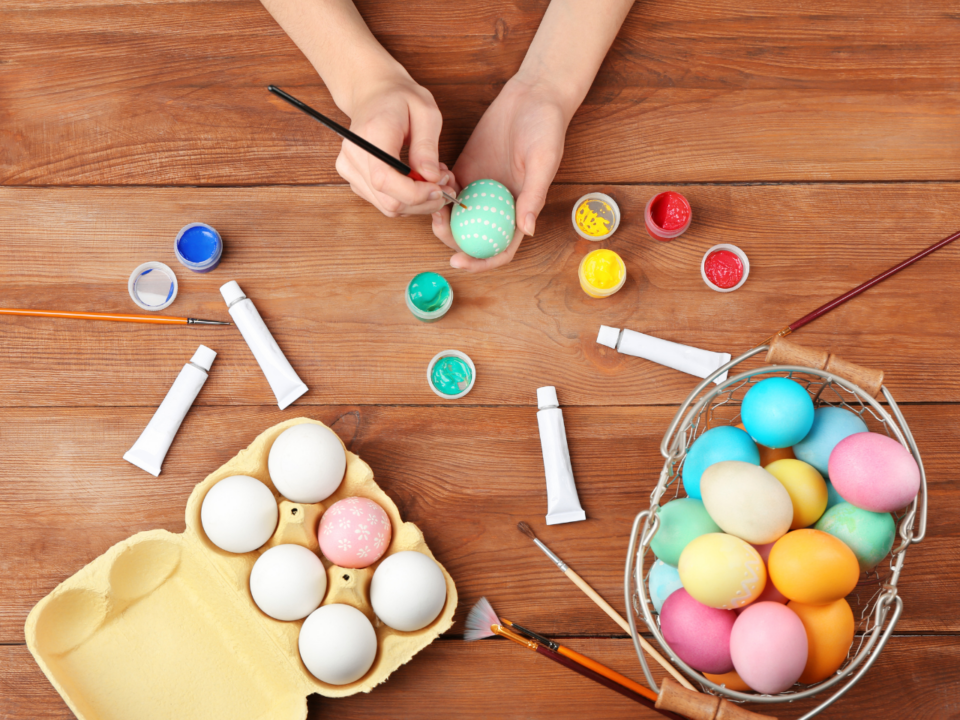 Easter crafts; person decorating an egg using paint