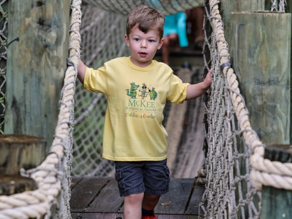 Vero Beach; child walking across rope bridge