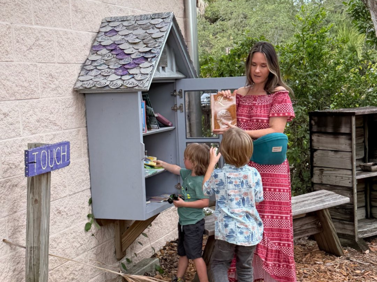 Vero Beach; family checking the little free library