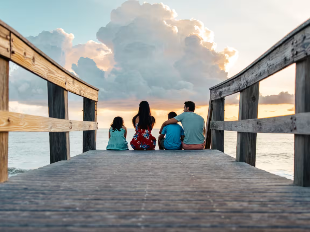 Vero Beach; family sitting at the end of the pier at sunset