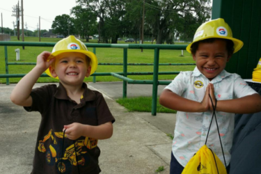 Touch a Truck; two kids wearing hard hats