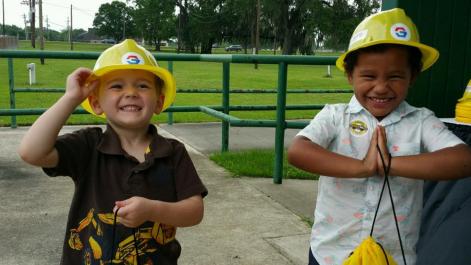 Touch a Truck; two kids wearing hard hats