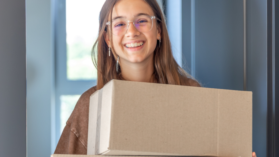 girl carrying boxes; move-in day