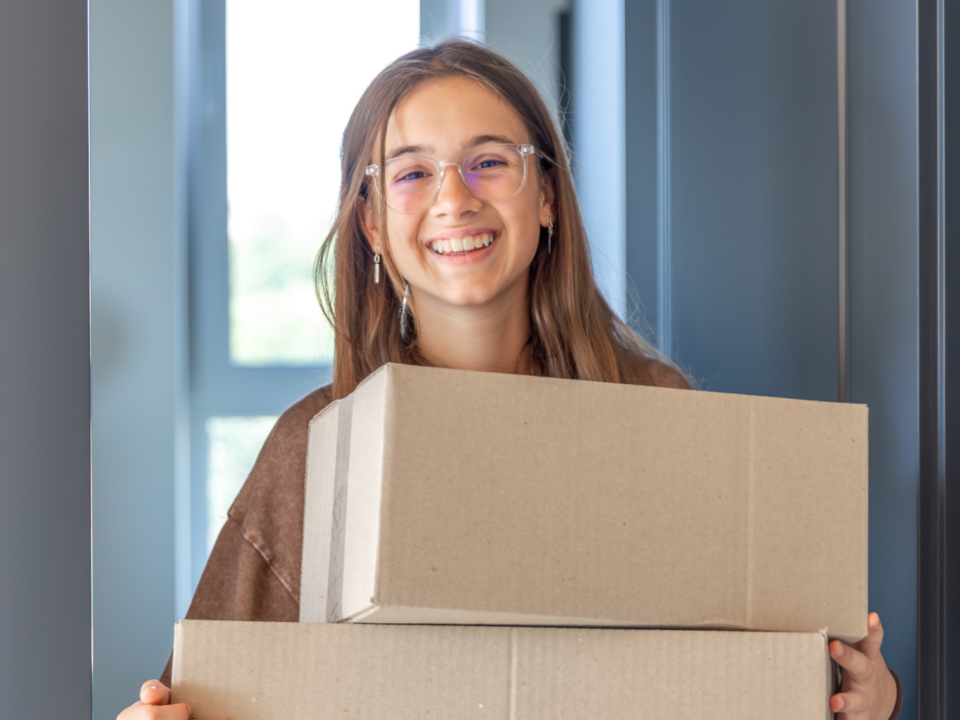 girl carrying boxes; move-in day