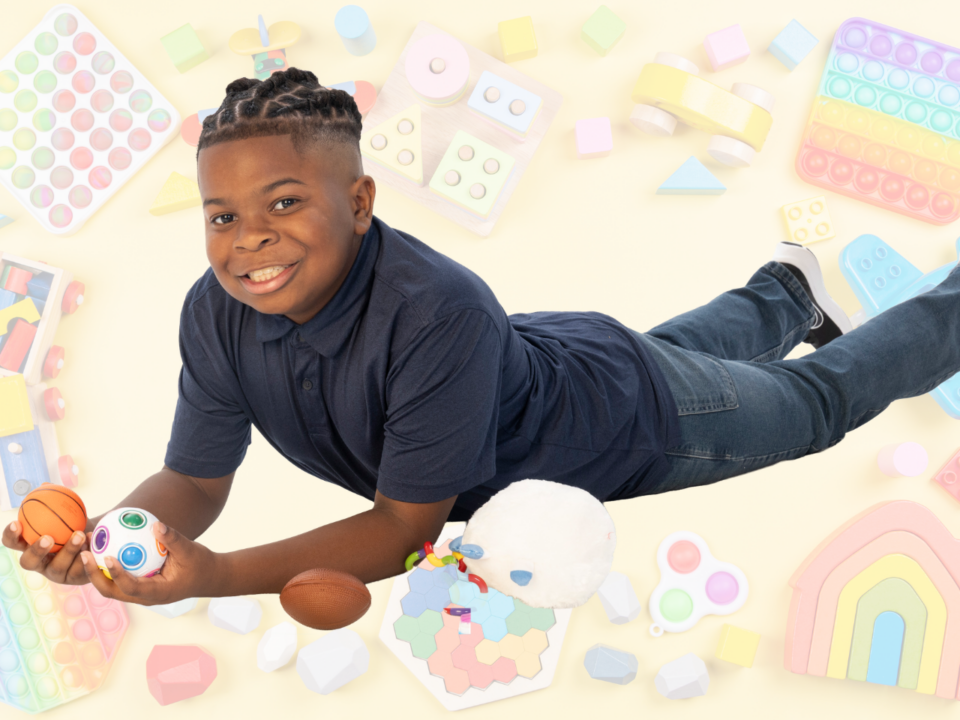 boy laying on floor with fidgets