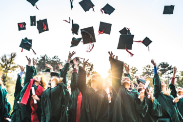 Gordon’s Grads; graduates throwing their caps in the air