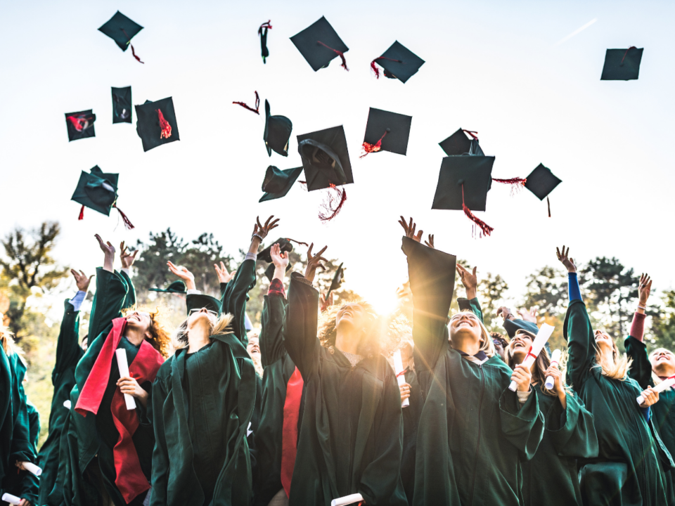 Gordon’s Grads; graduates throwing their caps in the air