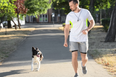 lsu vet med; man running with dog